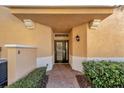 Cozy entryway with neutral tones and manicured shrubs providing a welcoming first impression at 130 Bella Vista Ter # 10A, Nokomis, FL 34275