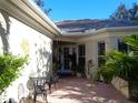 Relaxing courtyard features brick pavers, seating, and a sun decoration on the wall at 1354 Tearose Pl, Sarasota, FL 34239