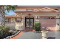 Charming home entrance with a decorative gate, unique architecture, and well-maintained landscaping at 1444 Ridgewood Ln, Sarasota, FL 34231