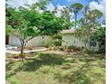 A beautifully landscaped yard surrounds this bright and inviting single-Gathering home at 1805 Springwood Dr, Sarasota, FL 34232