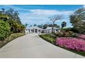 Beautiful landscaping adds to the curb appeal of this home with an extra large driveway at 1909 Field Rd, Sarasota, FL 34231