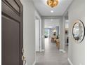 Elegant foyer with tile flooring and views of the open-concept living spaces beyond at 253 Tracino Ter, Nokomis, FL 34275