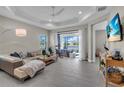Spacious living room with lots of natural light, tile flooring, and access to the outdoor patio at 253 Tracino Ter, Nokomis, FL 34275