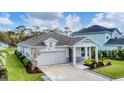 Charming single-story home featuring a two-car garage and manicured lawn at 2538 Fireflag Ln, Sarasota, FL 34232