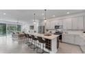 Open concept kitchen with stainless steel appliances and large central island at 2538 Fireflag Ln, Sarasota, FL 34232
