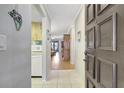 Inviting foyer leading into the living spaces with wood floors and a glimpse of natural light at 2808 60Th W Ave # 1603, Bradenton, FL 34207