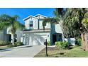 Inviting two-story home featuring a two-car garage, landscaping, and a covered front porch at 2904 N Ola Ave, Tampa, FL 33602