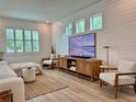 Bright living room with shiplap accent wall, and a large TV for entertainment at 2904 N Ola Ave, Tampa, FL 33602