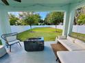 Relaxing outdoor patio area with a fire pit, cozy seating, and view of the landscaped backyard at 2904 N Ola Ave, Tampa, FL 33602