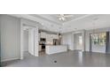 Open-concept living space features a modern kitchen with stainless steel appliances and ample natural light at 3838 Manorwood Loop, Parrish, FL 34219