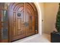 Elegant double front doors with detailed woodwork and side windows, creating a grand entrance at 3909 Casey Key Rd, Nokomis, FL 34275
