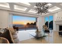 Bright living room with tile flooring, decorative lighting, and expansive sliding doors showcasing ocean views at 3909 Casey Key Rd, Nokomis, FL 34275