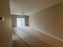 A large living room featuring neutral walls, a ceiling fan and access to outdoor patio at 3958 Mediterranea Cir # 411, Sarasota, FL 34233