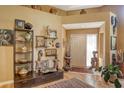 Elegant foyer featuring hardwood floors, high ceilings, and decoratively adorned with art and sculptures at 4141 Entrada Ct, Sarasota, FL 34238