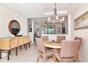 Inviting dining area with a round table, stylish chairs, and a unique chandelier at 4210 Overture Cir, Bradenton, FL 34209