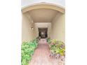 Brick hallway leading to a door, flanked by garden beds at 4210 Overture Cir, Bradenton, FL 34209