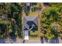 Overhead view of the home, showcasing its neat roof, driveway, and lush surrounding greenery at 4793 Lovett Rd, North Port, FL 34288