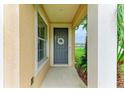 Welcoming front door entrance with decorative wreath and neutral-toned walls at 5015 98Th E Ave, Parrish, FL 34219