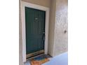 Front door of unit 102 featuring a 'Beach Please!' doormat and a secure entrance at 5168 Northridge Rd # 102, Sarasota, FL 34238
