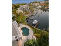 Waterfront home featuring a private pool, boat dock, lush landscaping and direct access to the bay at 520 Harbor Cay Dr, Longboat Key, FL 34228