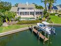 Beautiful waterfront home with a private dock, boat lift, large back patio, and an inground swimming pool at 520 Harbor Cay Dr, Longboat Key, FL 34228