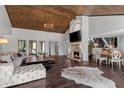 Open-concept living room with hardwood floors, fireplace, and access to the dining area for seamless entertaining at 520 Harbor Cay Dr, Longboat Key, FL 34228