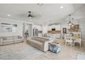 Open-concept living space with a ceiling fan, light gray walls, and a spacious dining area at 5750 Long Shore Loop, Sarasota, FL 34238