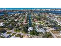 Stunning aerial view of waterfront community, home with pool, and boat dock with access to bay and ocean at 6136 Hollywood Blvd, Sarasota, FL 34231