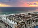 A serene view of condominiums located close to the beach with beautiful sky at 6512 Midnight Pass Rd # 504, Sarasota, FL 34242