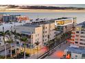 A stunning condominium building with a sunset over the ocean, near the white sandy beach at 6512 Midnight Pass Rd # 504, Sarasota, FL 34242