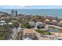 An aerial view of the property showcasing proximity to the beach, ocean views and pond at 6924 Bochi Cir, Sarasota, FL 34242