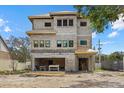 Under-construction multi-story home with stacked gray bricks near the two-car garage at 6924 Bochi Cir, Sarasota, FL 34242