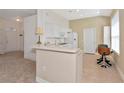 Bright kitchen with white appliances and cabinets, complemented by a convenient breakfast bar at 708 Foggy Morn Ln, Bradenton, FL 34212
