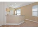 Open living space with carpet and neutral walls, offering a clean and versatile backdrop at 708 Foggy Morn Ln, Bradenton, FL 34212