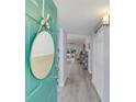 Bright foyer with gray vinyl floors leads to an open-plan kitchen and living area with a view to the lanai at 7294 Cloister Dr # 7, Sarasota, FL 34231