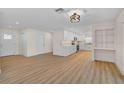 Bright living space with light wood floors, seamlessly connecting to the updated kitchen at 7523 S Leewynn Dr, Sarasota, FL 34240