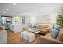 Open-concept living room and kitchen with modern finishes and comfortable seating at 7701 Palm Dr, Holmes Beach, FL 34217