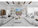 Spacious living room with fireplace, marble accents, built-in shelving, and two comfortable sofas at 8227 Nevis Run, Bradenton, FL 34202