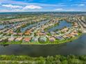 Beautiful aerial view of a waterfront community with lush greenery and lake access at 8328 Barton Farms Blvd, Sarasota, FL 34240