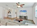Open-concept living room featuring neutral paint, ceiling fan, and tile flooring at 115 64Th E Ave, Bradenton, FL 34203