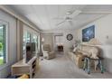 Cozy living room with a comfortable seating area, a ceiling fan, and great natural light at 1416 41St E Ave, Ellenton, FL 34222