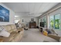 Bright living room featuring a comfortable sofa, a ceiling fan, and large windows at 1416 41St E Ave, Ellenton, FL 34222