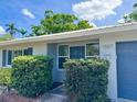 Single-story home featuring mature landscaping, charming windows, and a stylish attached garage at 1507 30Th W St, Bradenton, FL 34205