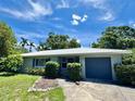Inviting single-story home with manicured landscaping, a well-maintained lawn and a driveway leading to an attached garage at 1507 30Th W St, Bradenton, FL 34205
