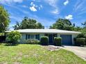 Inviting single-story home with manicured landscaping, a well-maintained lawn and a driveway leading to an attached garage at 1507 30Th W St, Bradenton, FL 34205