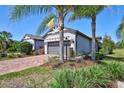 Charming single-Gathering home featuring a two-car garage, a brick driveway, and well-maintained landscaping at 17042 Hampton Falls Ter, Bradenton, FL 34202