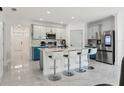 Modern kitchen with a large island, white countertops, and stainless steel appliances at 177 Tierra Verde Way, Bradenton, FL 34212