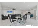 Open-concept living space with dining area, modern kitchen, and comfortable seating at 177 Tierra Verde Way, Bradenton, FL 34212