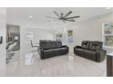 Bright living area with sleek tile flooring, modern furniture, and ceiling fan at 177 Tierra Verde Way, Bradenton, FL 34212