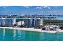 A beautiful beachside condominium building features amazing views, waterfront access, and beachside relaxation on a sunny day at 1800 Benjamin Franklin Dr # B208, Sarasota, FL 34236